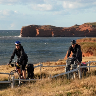 Two people cycling in the Îles de la Madeleine