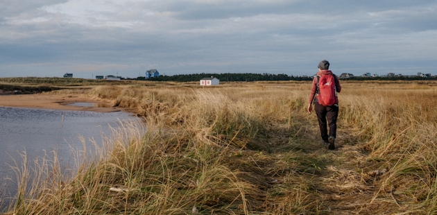 Woman hiking in the Îles de la Madeleine in the fall