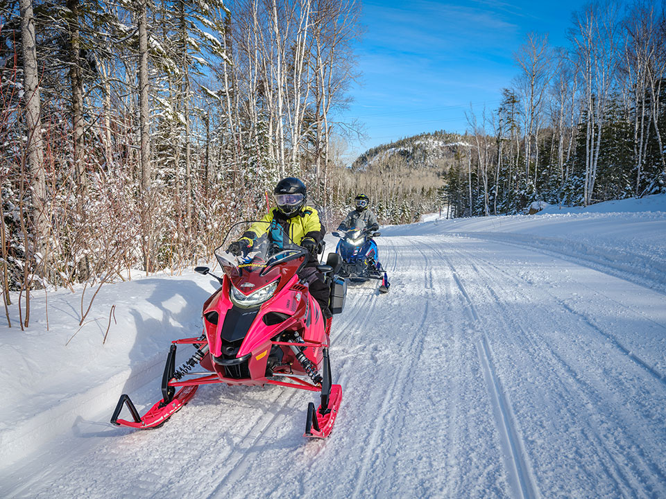 Snowmobilers on a trail in Eastern Québec