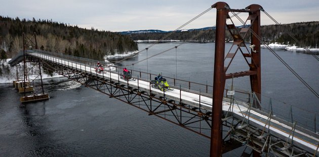 Snowmobilers on the snowmobile bridge over the Manicouagan River