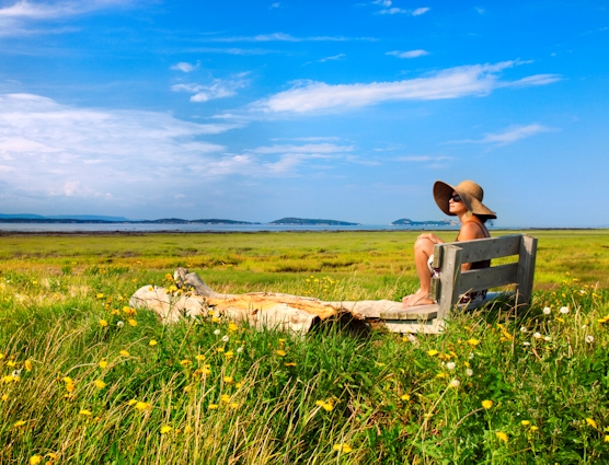 Woman admiring the sea in Kamouraska in Bas-Saint-Laurent